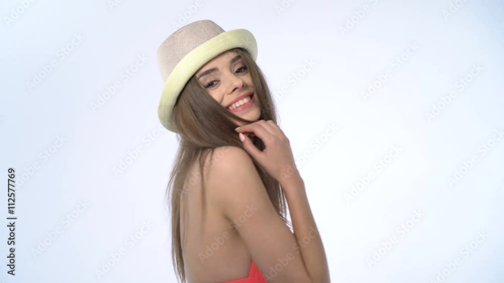Happy young brunette woman wearing pink bikini and hat on white background Happy young brunette woman wearing pink bikini and hat on white background