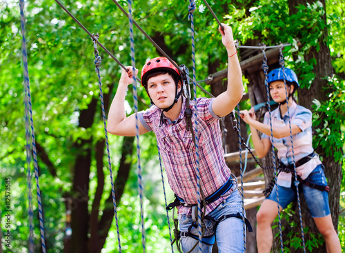 adventure climbing high wire park - people on course in mountain