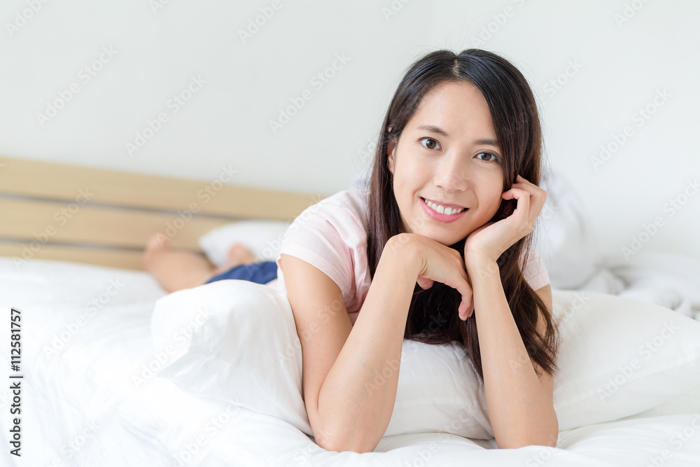 Woman lying on the bed at home Woman lying on the bed at home