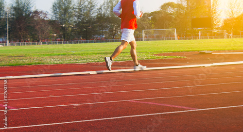 Healthy Living Concept. Man running in field Motion blur, Sunset time.