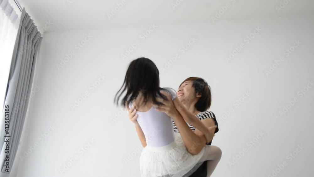 Slow motion Mother spinning her daughter at home Slow motion Mother spinning her daughter at home