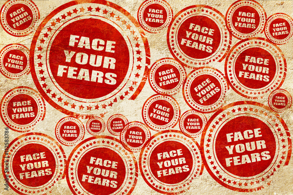 Fototapeta premium face your fears, red stamp on a grunge paper texture