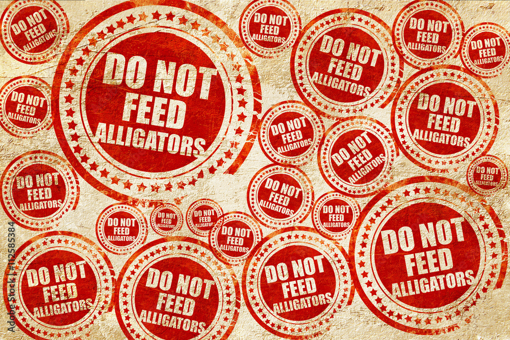 do not feed alligators, red stamp on a grunge paper texture do not feed alligators, red stamp on a grunge paper texture