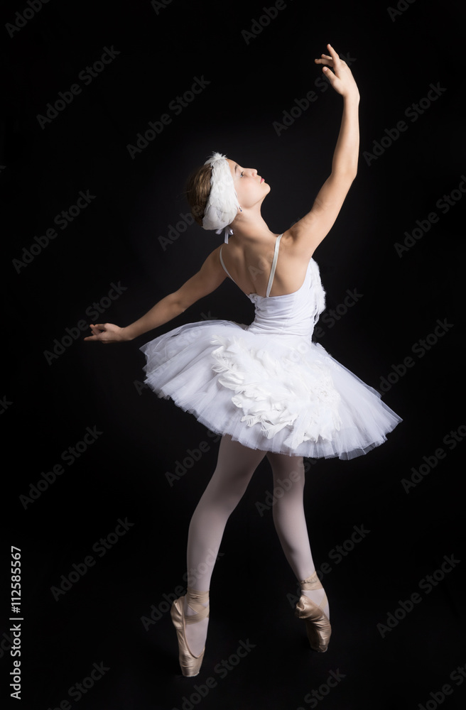 Naklejka premium Ballerina is dancing on a black background