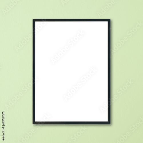 Mock up blank frame hanging on wall in room.