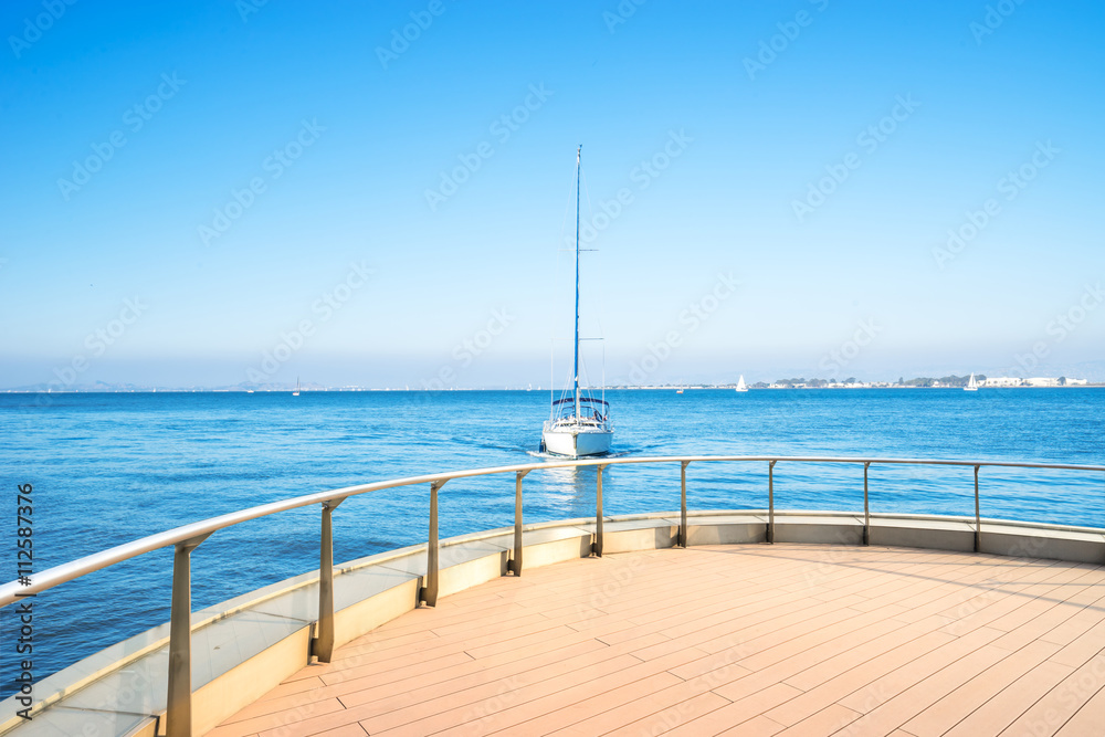 luxury white sail boat sailing on sea in blue sky