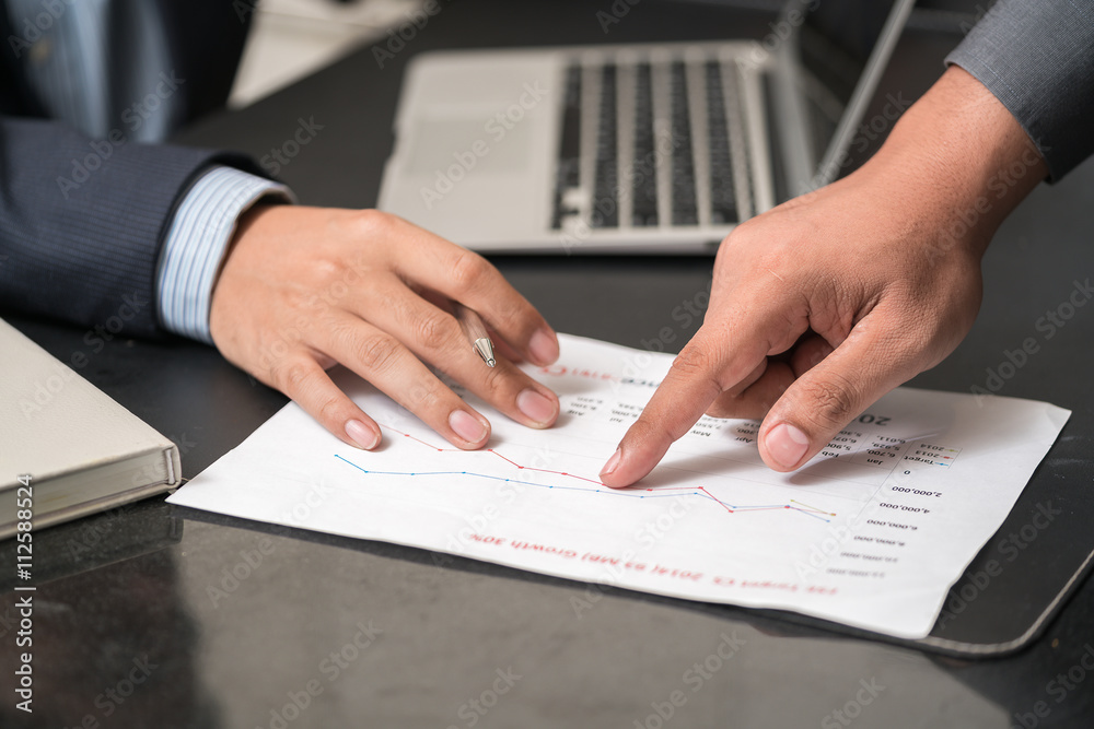 Image of human hands with pens over business document at meeting
Image of human hands with pens over business document at meeting