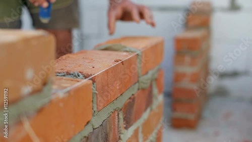 Work lays bricks on a construction site