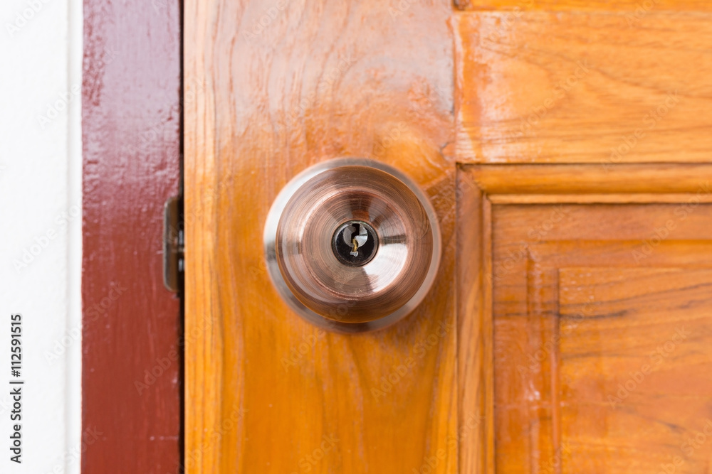 door knob and keyhole on wooden door