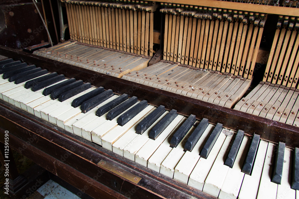 Old broken disused piano with damaged keys Old broken disused piano with damaged keys
