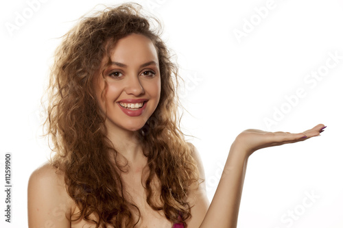 smiling beautiful woman holding imaginary object in her hand