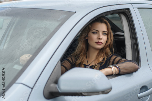 Girl sits in a car as a driver © alexshalamov