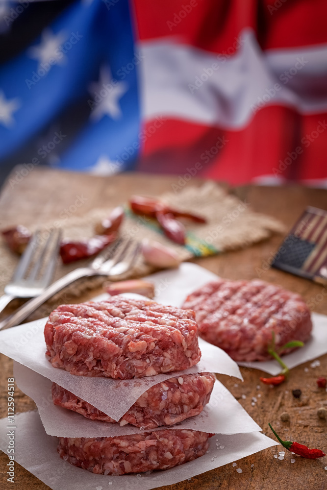 Raw Ground beef meat Burger patties at picnic table Raw Ground beef meat Burger patties at picnic table