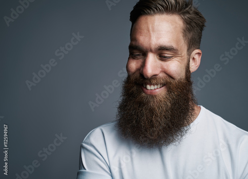 Canvas Print Happy young man with large fuzzy beard