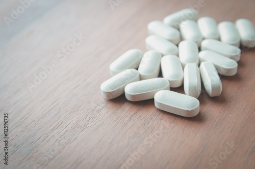 medicine pill on wood table