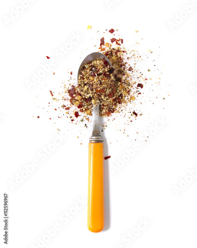 A teaspoon of spices isolated on a white background