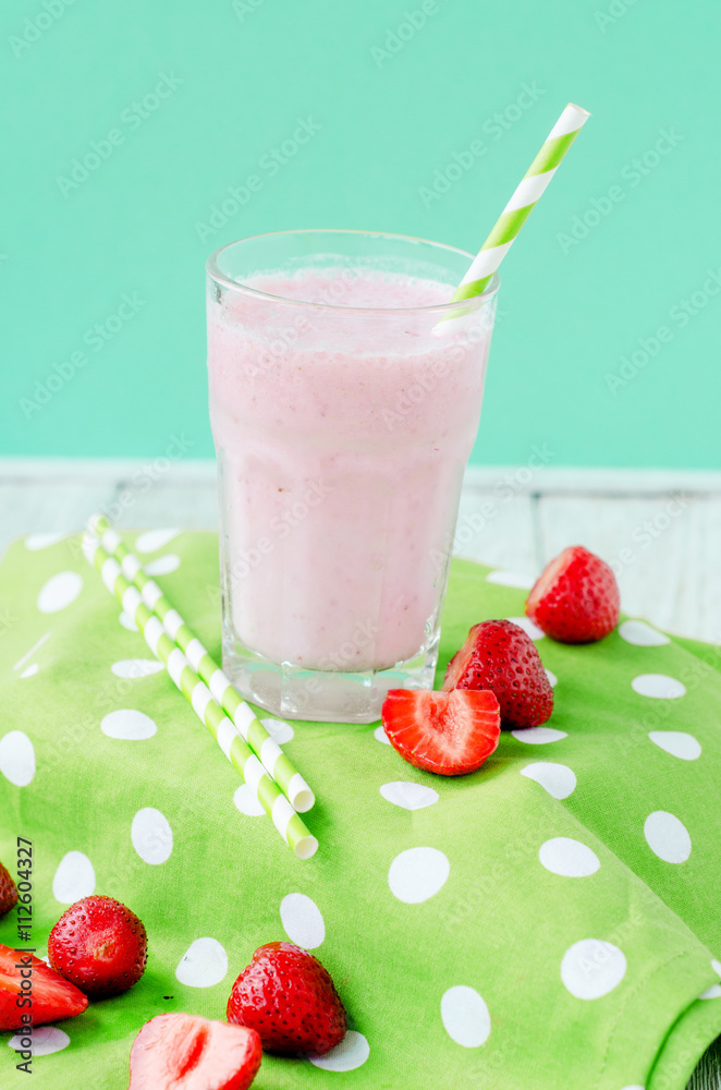 Summer refreshing cold drink , a milkshake with strawberries on a bright color background
Summer refreshing cold drink , a milkshake with strawberries on a bright color background