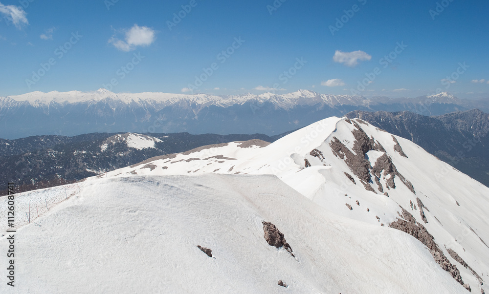 snow-covered mountain peak and blue sky background