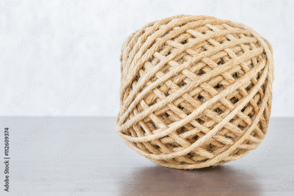 Hemp ball on wooden table with copyspace with selective focus. Hemp ball on wooden table with copyspace with selective focus.