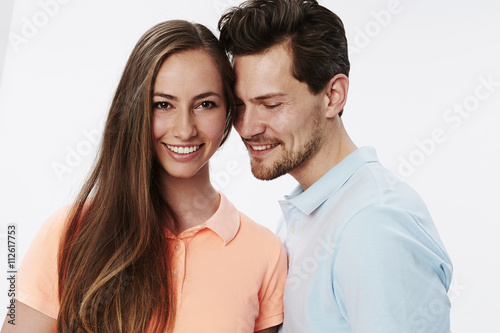 Happy smiling couple in white studio