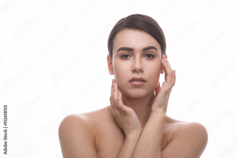 Closeup portrait of beautiful woman looking at camera and touching her face over white background. Plastic surgery and cosmetology concepts. Closeup portrait of beautiful woman looking at camera and touching her face over white background. Plastic surgery and cosmetology concepts.