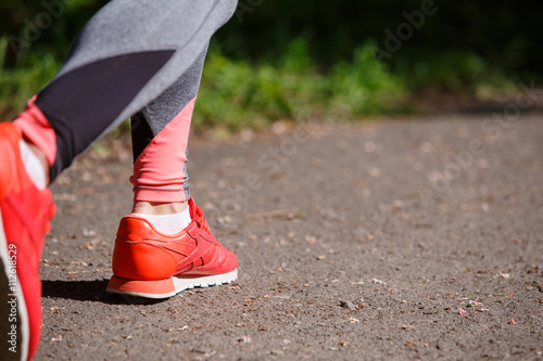 young fitness woman hiker legs at forest trail