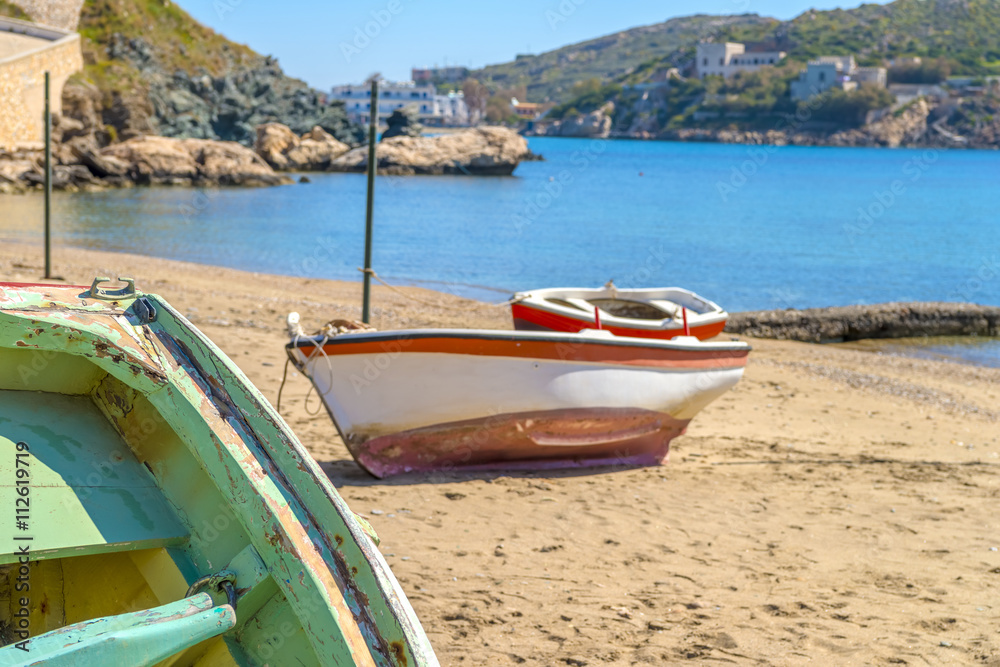 Traditional fishing boat on the shore during a sunny summer day.