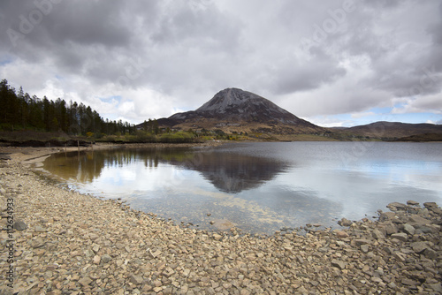 Mount Errigal, Co. Donegal, Ireland, reflected in blue lake surrounded by peatland in national park