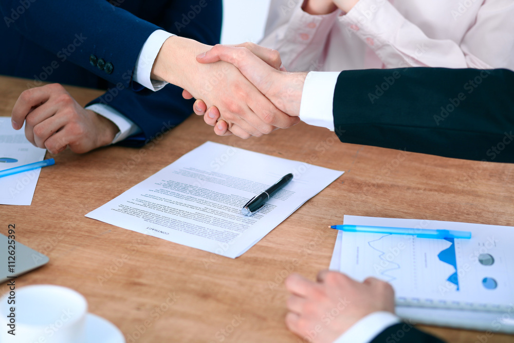 Business people shaking hands finishing up a meeting Business people shaking hands finishing up a meeting