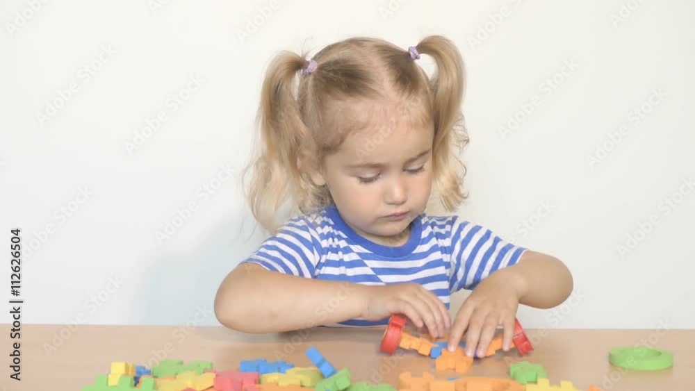 child little girl playing plastic constructor toys at home or kindergarten. child little girl playing plastic constructor toys at home or kindergarten.