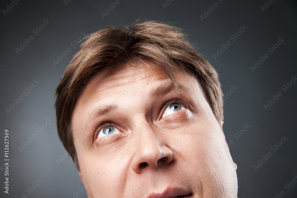 Fototapeta premium Curious adult man looking up