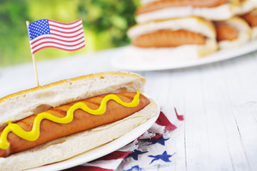 Hot dog on an outdoor table in bright light