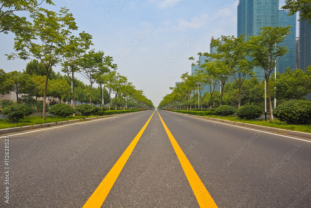 Empty road surface with modern city buildings background