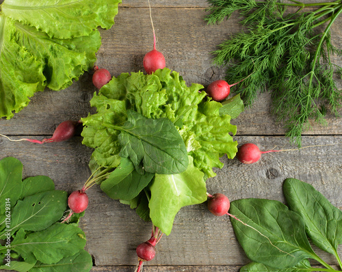 Organic food. ingredients for saladon old, rustic, wooden table. photo