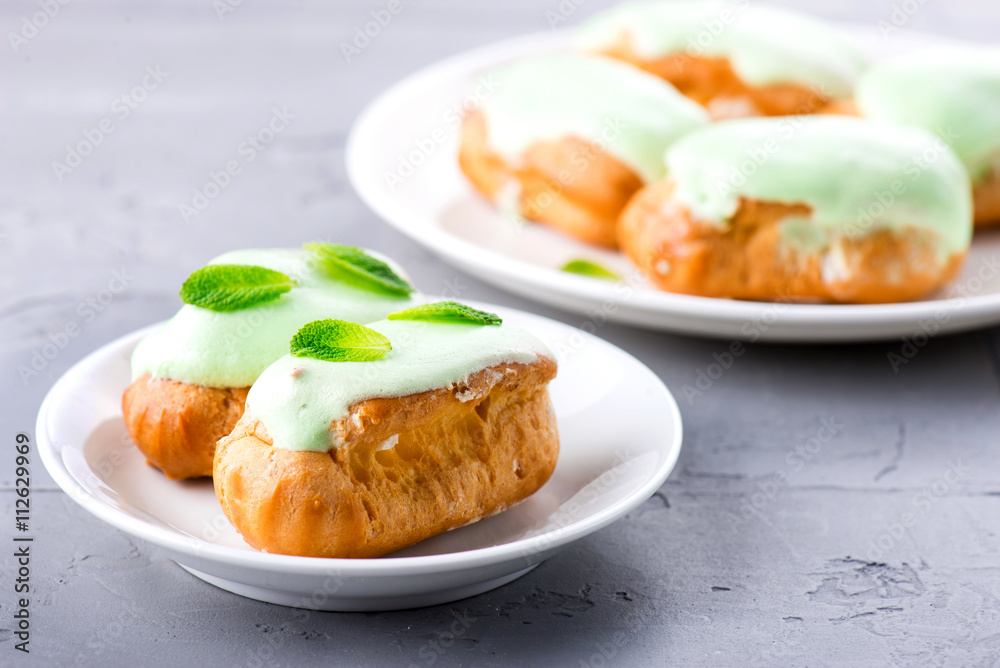 cream dessert eclair with fresh mint leaves
