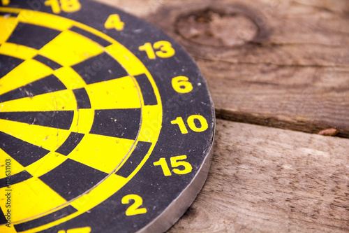 Darts dartboards, on a brown wooden Board. Table for the game of Darts. the success failure of the business concept. Closeup. place for text photo