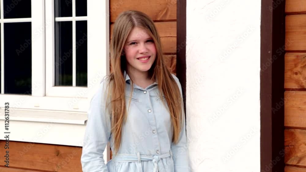Video portrait of young happy smiling girl on the background of her home HD Video portrait of young happy smiling girl on the background of her home HD