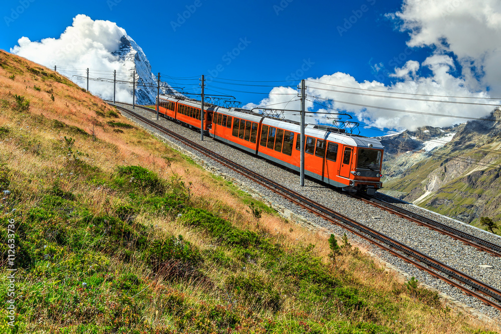 Electric tourist train and famous misty Matterhorn peak,Switzerland,Europe