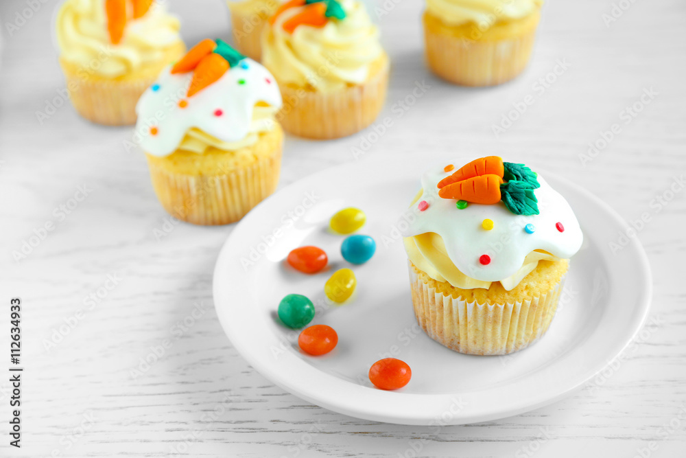 Plate with Easter cupcake on wooden table Plate with Easter cupcake on wooden table