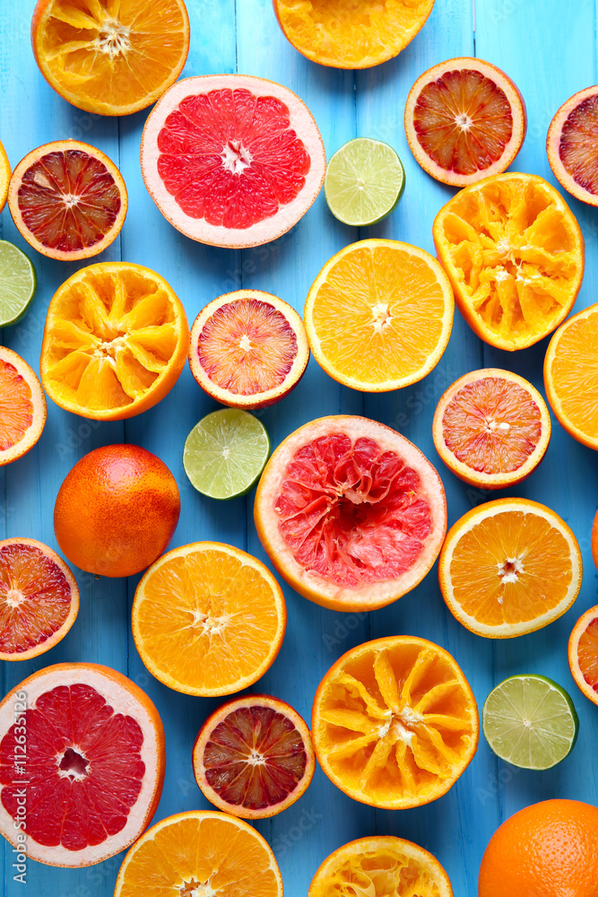 Juicing delicious citruses on blue wooden table Juicing delicious citruses on blue wooden table