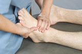 Chiropractor /physioterapist doing a feet massage