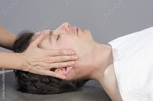 Chiropractor /physioterapist assessing the muscles on a jaw