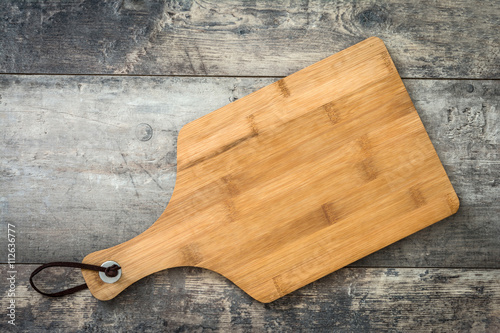 Cutting board on a wooden background 