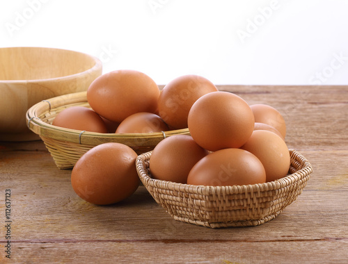 Eggs in a basket on the wooden floor
