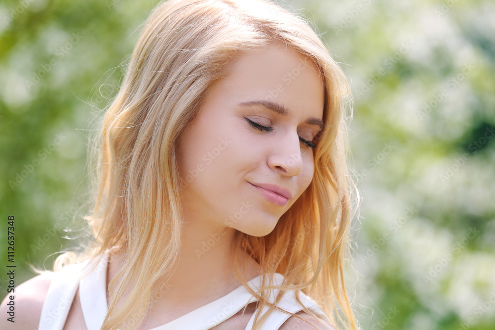 Young beautiful woman on blooming tree background Young beautiful woman on blooming tree background