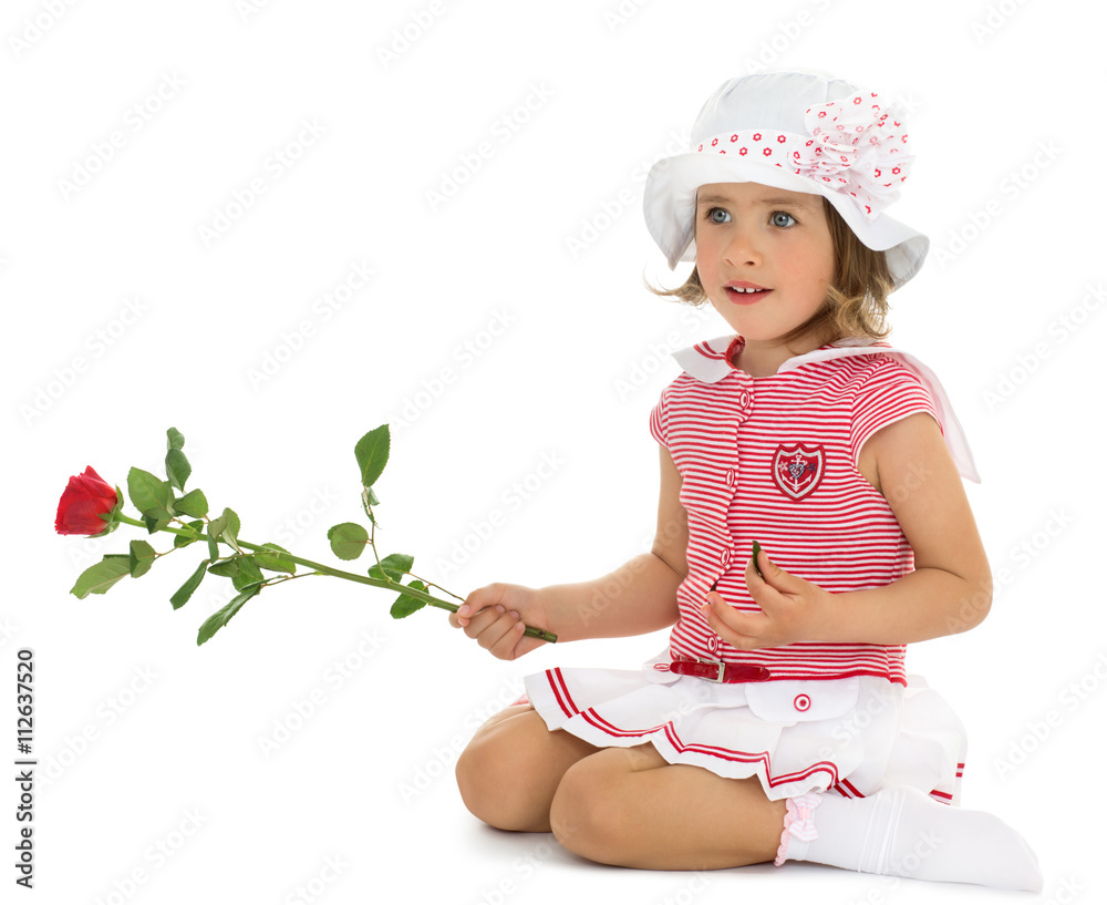 Beautiful little girl in a dressy summer dress and white Panama keeps in hand a rose - Isolated on white background Beautiful little girl in a dressy summer dress and white Panama keeps in hand a rose - Isolated on white background