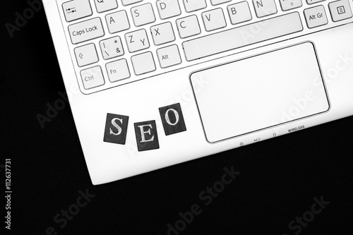 SEO - keyboard of laptop with letters. Optimalization of web pages for better search results. Black and white with copy space  photo