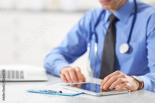Doctor using tablet for work in hospital