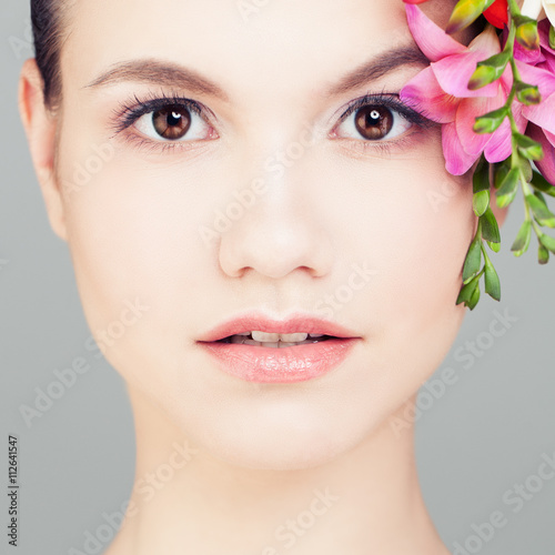 Beautiful Woman with Flowers. Face Closeup