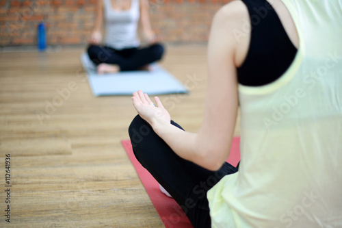 Young women do yoga indoors